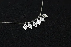 Detailed close-up of S925 sterling silver diamond-shaped pendant with precision stamping