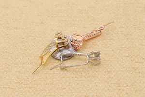 Macro view of S925 sterling silver heart charms with zircons next to a coin