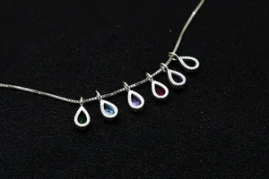 Close-up of S925 sterling silver chain with six colorful pear-cut zircon stone pendants