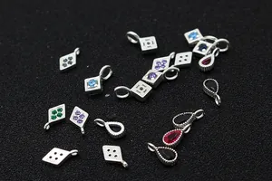 Detailed macro view of S925 sterling silver geometric pendants with colorful zircon stones