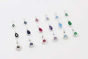 Detailed view of silver geometric charms with colorful zircons for DIY jewelry making