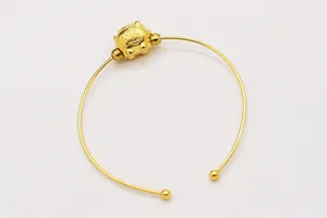 Detailed close-up of golden S925 silver screw cuff bracelet with Fu character bead