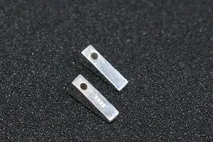 Macro detail of S925 sterling silver rectangular bead with polished finish and hallmark