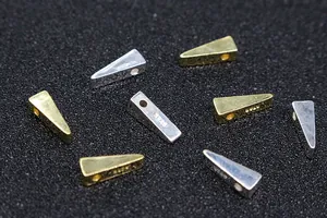Macro shot of S925 sterling silver triangle beads with visible hallmark for jewelry DIY