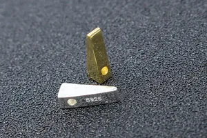 Close-up of S925 sterling silver triangle beads with metallic gold and silver finish