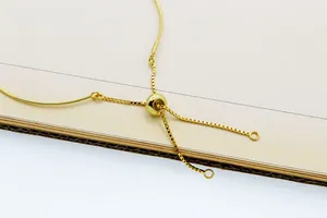 Detailed view of adjustable gold-plated box chain with sliding bead and DIY jewelry loops