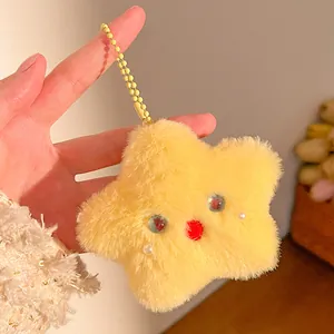 Detail of plush yellow star charm with cute facial features and yellow bead chain strap