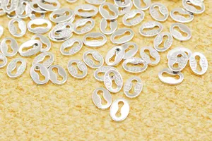 Macro shot of S925 sterling silver oval jewelry tags with Italy hallmark stamps