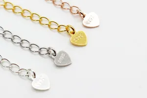 Detailed macro view of S925 sterling silver heart extension chains in four plating colors