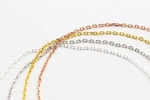 Macro detail of fine S925 sterling silver cable chains in silver, gold, and rose gold
