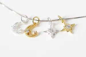 Macro detail of silver moon and star charms with micro-pave cubic zirconia stones