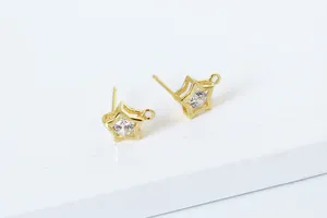 Macro view of gold S925 sterling silver star earrings with cubic zirconia and hanging loop