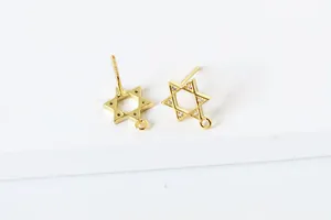 Close-up of gold star stud earring components with pavé zircon and bottom hanging loop
