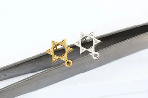 Close-up of S925 sterling silver star pendants with sparkling zircons and DIY loops