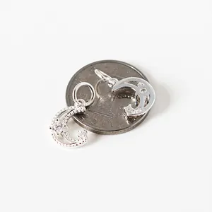 S925 sterling silver moon pendant with zircons displayed on a coin for scale