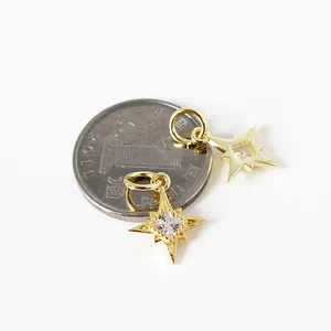 S925 silver gold-plated star pendants with cubic zirconia next to a coin for size