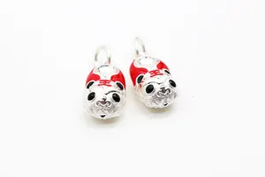 Detailed macro view of S925 sterling silver tiger head charms with red enamel DIY beads