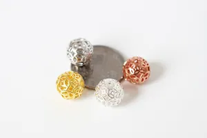 Macro view of hollow S925 silver coin pattern beads in gold and silver for DIY jewelry