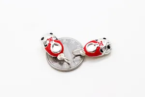 Macro detail of S925 sterling silver tiger shoes pendants with red enamel Fu character