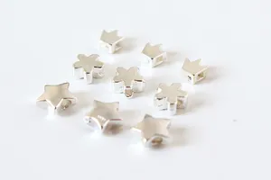 Macro view of S925 sterling silver DIY charms featuring star, crown, and flower shapes