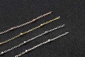 Detailed view of S925 sterling silver cross bead chains in four metallic finishes