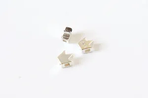 Macro detail of crown shaped S925 sterling silver DIY spacer beads with square hole