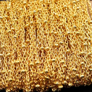 Macro detail of high-polish gold S925 silver cross chain with small integrated beads