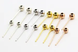 Macro shot of S925 sterling silver peg earring posts in gold, silver, and rose gold finishes