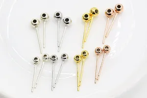 Macro shot of S925 sterling silver ball stud earring findings in gold and silver
