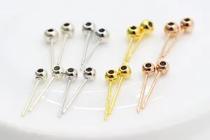 Macro view of S925 sterling silver ball head stud earrings in silver, gold, and rose gold
