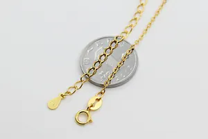 Macro shot of gold S925 sterling silver necklace with spring clasp and drop tag