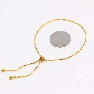 Adjustable gold box chain bracelet with spherical sliding clasp and metal beads