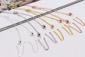 Detailed view of adjustable sterling silver cross chains in silver gold and rose gold