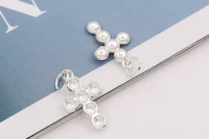Detailed view of S925 sterling silver cross charms with polished beads and hallmark