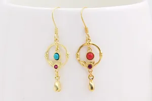 Detailed view of vintage gold-plated drop earrings featuring turquoise and red stones