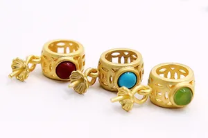 Macro detail of S925 silver cylinder pendant bail with turquoise and matte gold finish