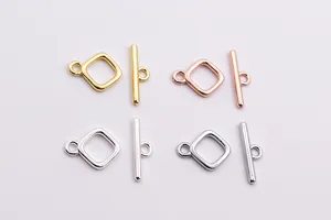 Macro detail of square toggle clasps in gold, silver, rose gold and platinum finishes