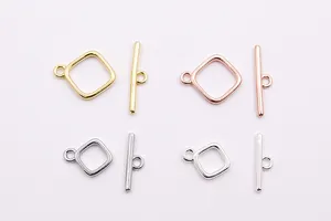 Macro view of four-color square OT toggles for DIY jewelry making in polished silver and gold