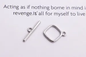 Macro detail of S925 sterling silver square OT toggle clasp with hallmark engraving