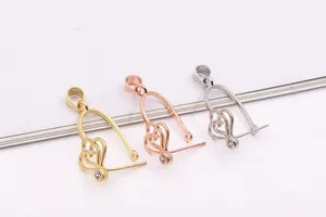 Detail of S925 sterling silver hollow heart pendants with crystals in gold and silver