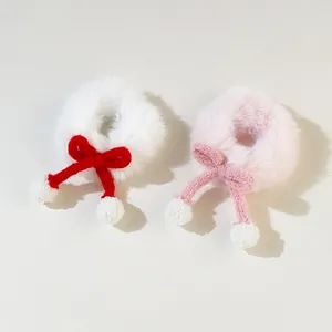 Cute plush bow hair tie in white and pink with soft fuzzy pom-poms for girls