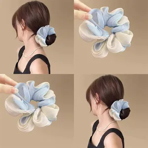 Blue and white gradient organza scrunchie hair tie showing multiple styling angles