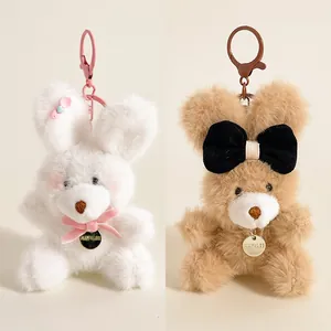 Porte-clés lapins en peluche blanc et marron avec nœuds colorés et anneau métal