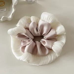 Detail of elegant double-layered lace mesh scrunchie with satin finish and ruffled edges