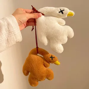 Close-up of cute plush duck keychain set with fuzzy texture and braided hanging cords