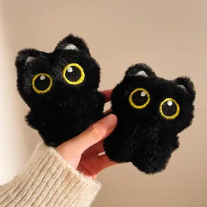 Pair of cute plush black cat charms with fluffy texture and large yellow embroidered eyes