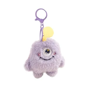 Schattige paarse pluche monster sleutelhanger met geel bloemoog en veerklem
