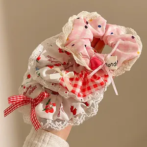 Detailed shot of sweet blue polka dot scrunchies with lace trim and strawberry charms