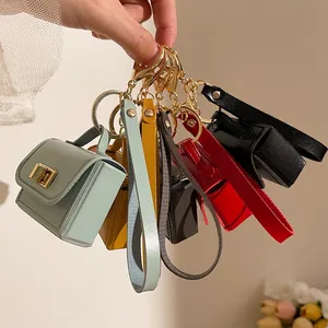 Portachiavi mini borsa in pelle PU in vari colori con moschettone dorato e anello in metallo