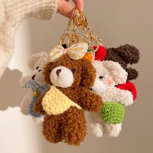 Detail of plush bear charms with curly fur, plaid bows and mini crossbody bags